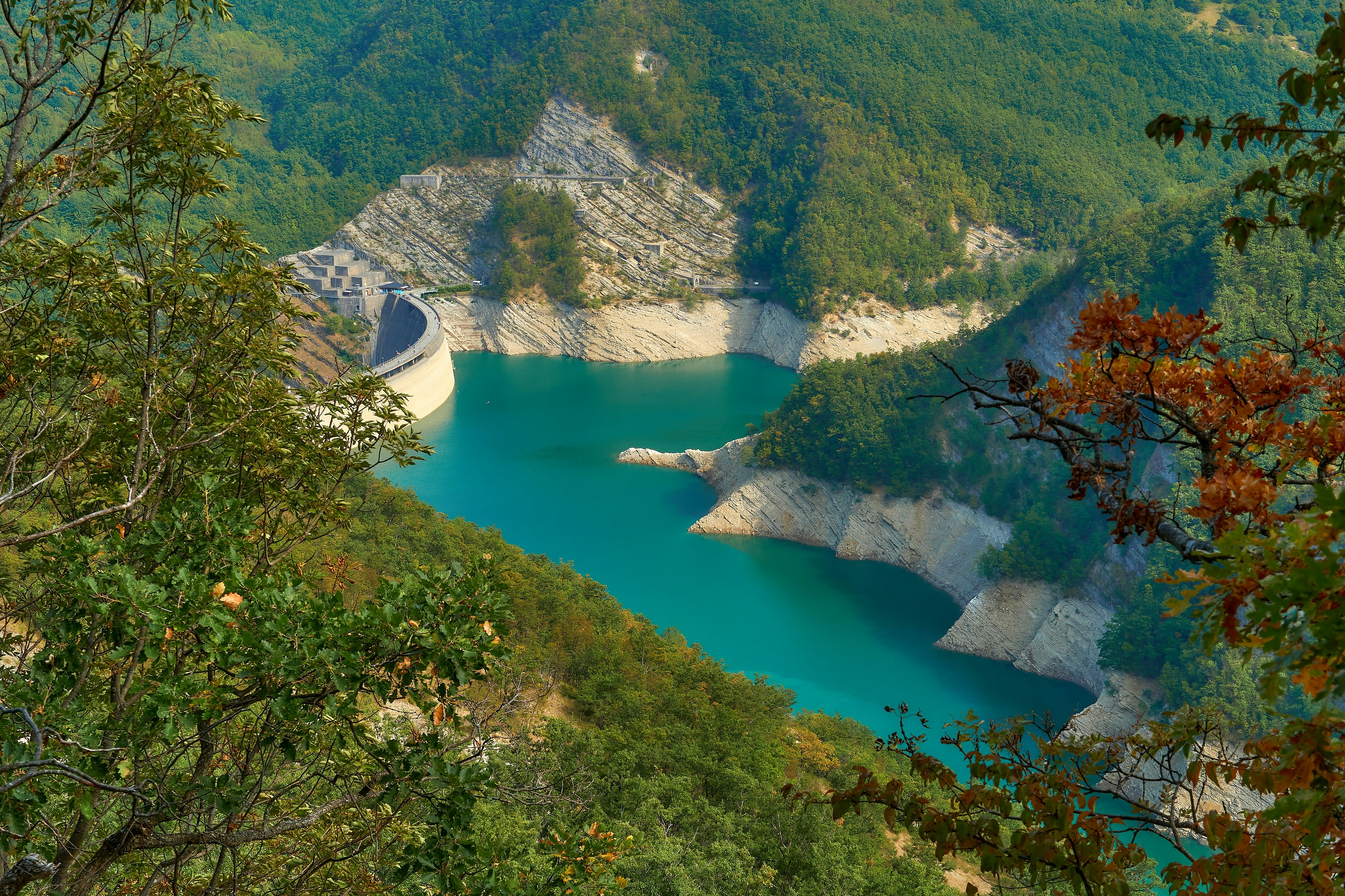 river in between green mountains during daytime